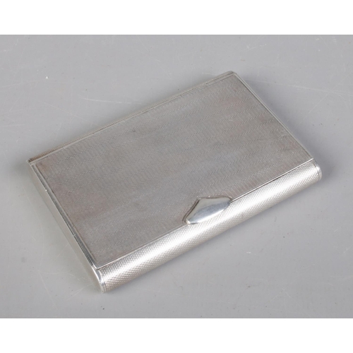 39 - An Art Deco silver cigarette case with engine turned decoration. Contents of Player's Weights cigare... 