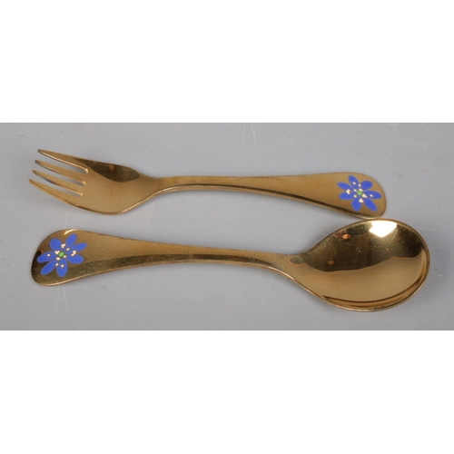 48 - A silver gilt fork and spoon set by Georg Jensen, with matching enamel blue floral decoration to eac... 
