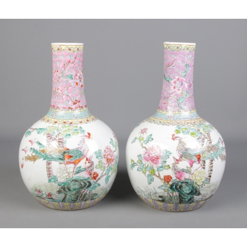 51 - A large pair of Chinese Famille Rose bottle vases. Decorated with peacocks and flowers. Jingdezhen m... 