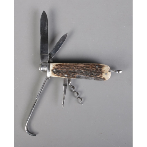 53 - An early 20th century coachman's penknife by John Watts of Sheffield. With stag horn scales, two bla... 