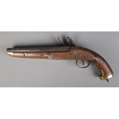 58 - A late eighteenth century flintlock cavalry pistol. With walnut full stock and brass mounts. Barrel ... 