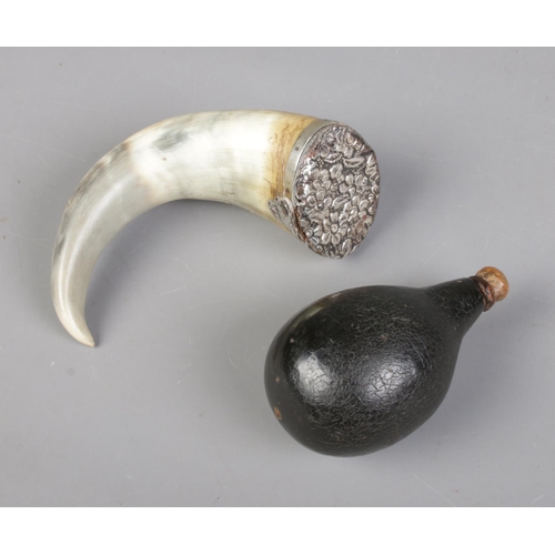 69 - Two antique powder flasks. Includes horn example with white metal top and gourd example.