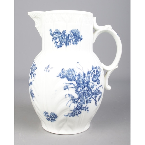 7 - A Worcester cabbage leaf jug with Bacchus mask, scrolled handle and transfer printed floral sprays. ... 