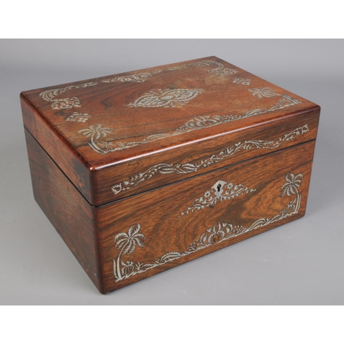 83 - A Victorian rosewood vanity box and contents. Having mother of pearl inlay, fitted interior and side... 