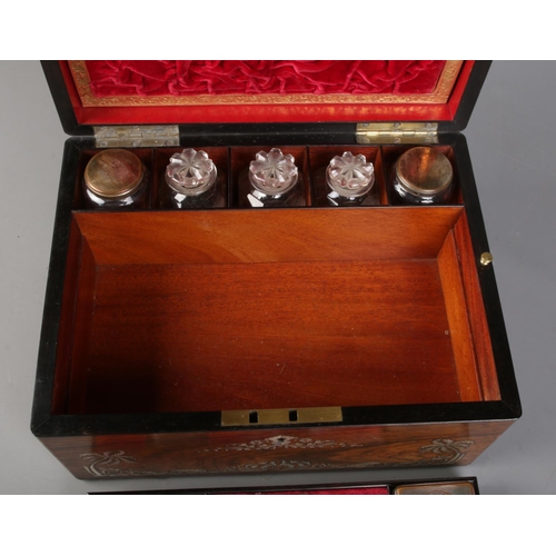 83 - A Victorian rosewood vanity box and contents. Having mother of pearl inlay, fitted interior and side... 