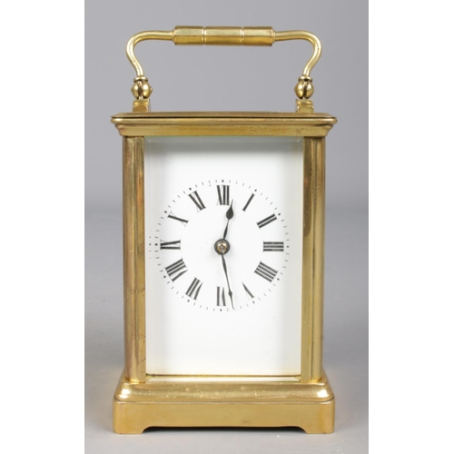 85 - A French brass carriage clock with leather and glass travel case. Having Roman numeral markers and c... 