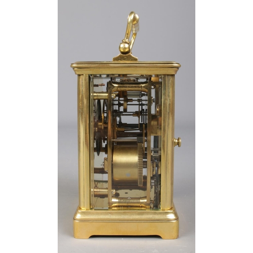 85 - A French brass carriage clock with leather and glass travel case. Having Roman numeral markers and c... 