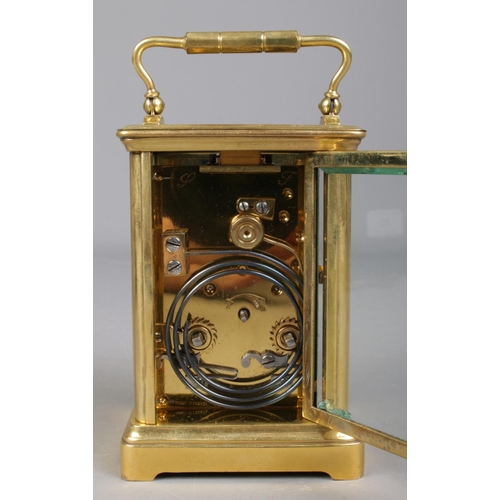 85 - A French brass carriage clock with leather and glass travel case. Having Roman numeral markers and c... 