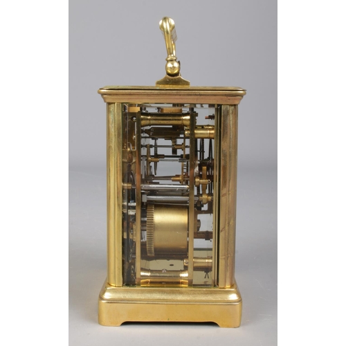 85 - A French brass carriage clock with leather and glass travel case. Having Roman numeral markers and c... 