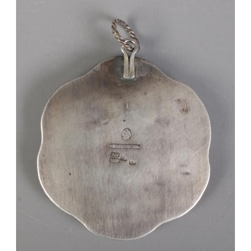 87 - A 19th century Russian silver pendant. With central carved mother of pearl panel depicting a warrior... 