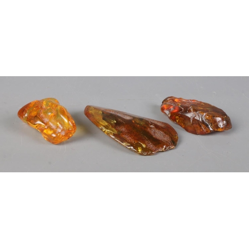 224 - Three raw shards of amber. 156g.