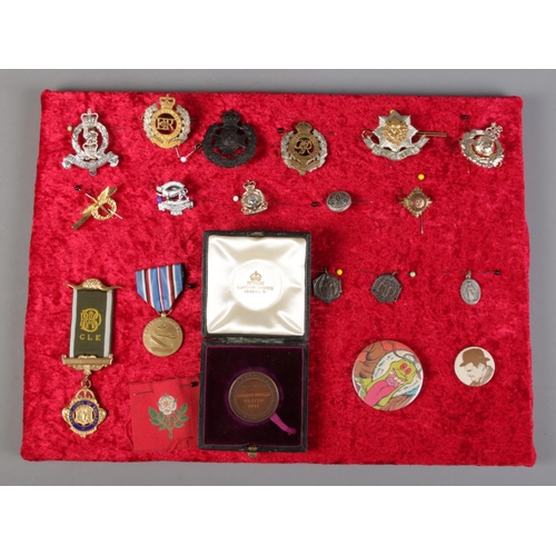 234 - A display tray of badges and medals, to include Army and Royal Engineers examples.