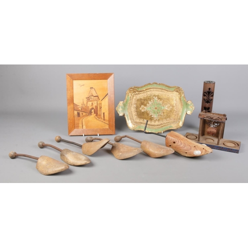 290 - A collection of woodenwares, including gilt decorated tray and a quantity of shoe trees.