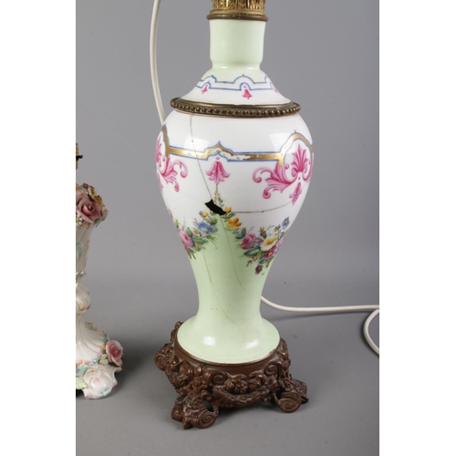 330 - Two ceramic table lamps, one with floral detailing, the other with a decorative metal base. Complete... 