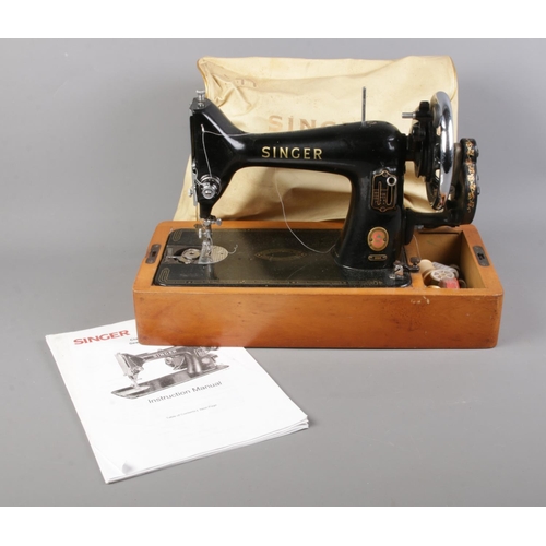 333 - A Singer 99K sewing machine in base, with instruction manual.