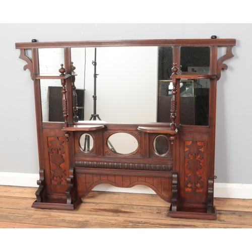 362 - An mahogany over mantle mirror, with carved panels and large turned supports. Height: 105cm, Width: ... 