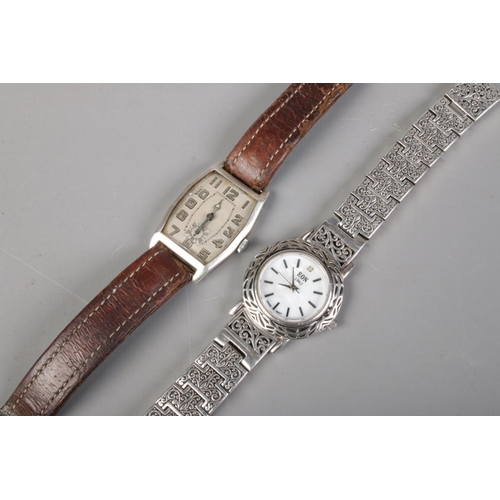 410 - A vintage manual silver watch with leather strap, together with a ladies EON quartz wristwatch with ... 