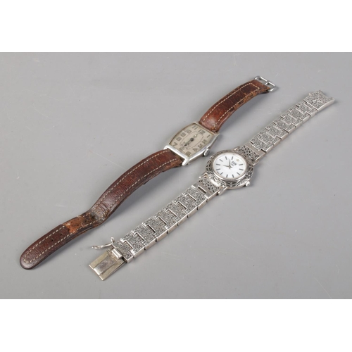 410 - A vintage manual silver watch with leather strap, together with a ladies EON quartz wristwatch with ... 