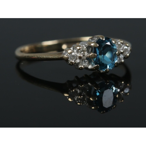 416 - A 9ct Gold 'London Blue' topaz and diamond ring, size J½. Total weight: 1.2g