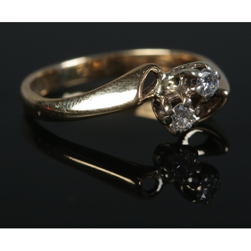 424 - A 9ct Gold and two stone diamond crossover ring. Size L½. Total weight: 2.2g.