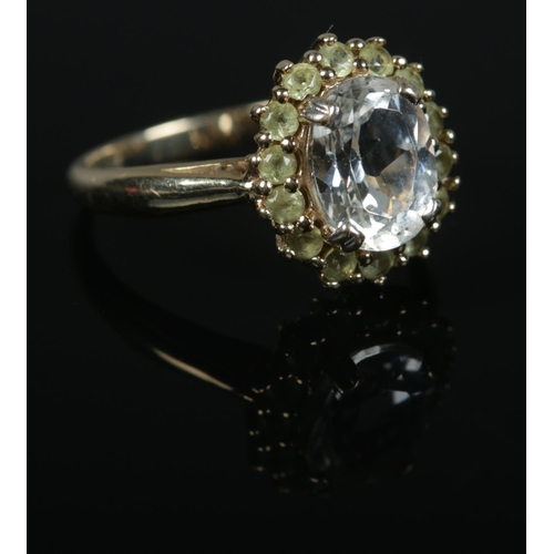 428 - A9ct Gold topaz and tsavorite garnet halo ring. Size N. Total weight: 3.9g