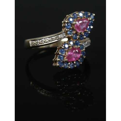 435 - A 9ct Gold sapphire, ruby and diamond crossover dress ring. Size N½. Total weight: 4.7g