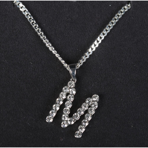 466 - A silver 'letter M' pendant set with clear coloured stones on silver chain. In Georg Jensen box.