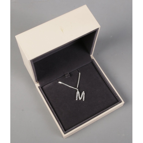 466 - A silver 'letter M' pendant set with clear coloured stones on silver chain. In Georg Jensen box.