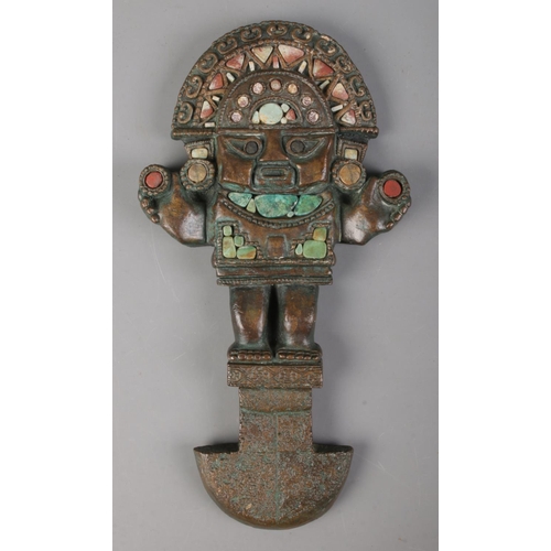 479 - After antiquity; a bronze plaque of an Inca Tumi, set with stonework to the body. Length: 33cm.