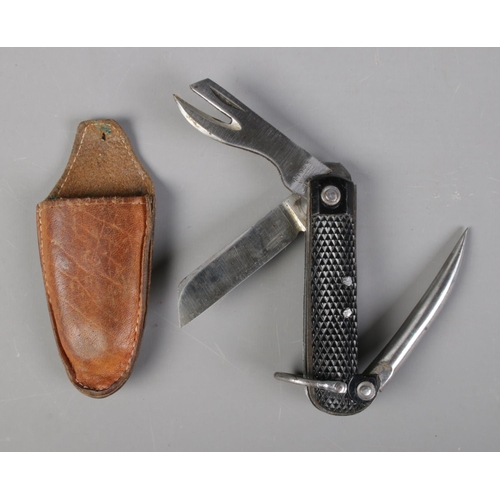 505 - A 1943 Watts of Sheffield multi bladed military knife in pouch, bearing broad arrow mark to the blad... 