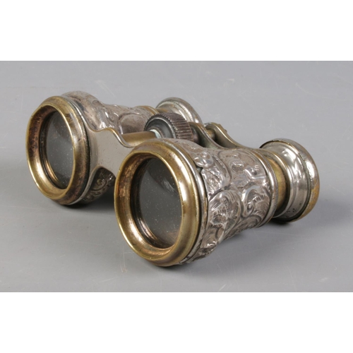 511 - A pair of Victorian silver bodied opera glasses, with embossed decoration. Assayed for Birmingham, 1... 