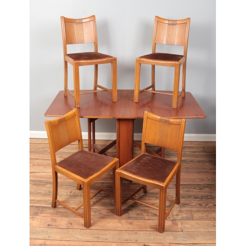 529 - A mid twentieth century teak McIntosh drop leaf dining table, together with four dining chairs. Dime... 