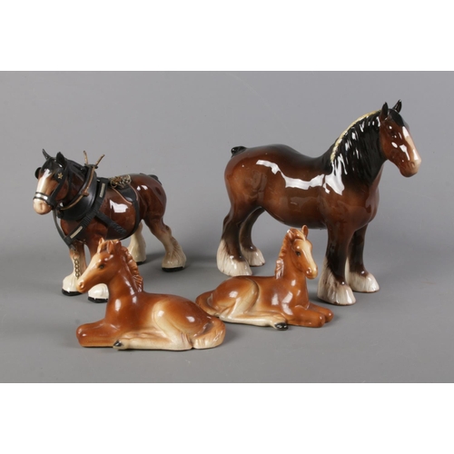 135 - A collection of ceramic horses including Beswick shire horse, one shire horse in tack and two restin... 