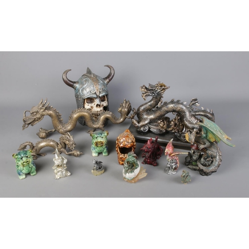 218 - A collection of dragon figures including several oriental style examples. Also includes large skull ... 