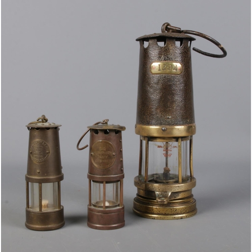 235 - A small Protector Lamp & Lighting Company miners lamp along with two other stamped 1292 and Sir Hump... 