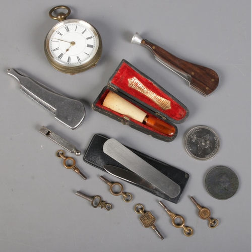 244 - A small box of collectables. Including pocket watch, pipe, pocket knives, watch keys, etc.