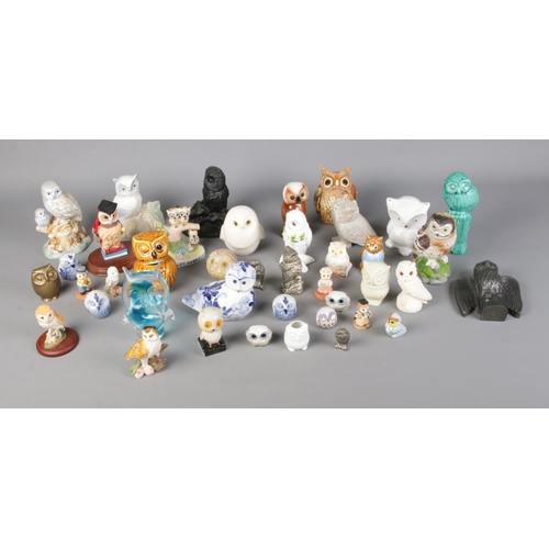 309 - A large collection of figures modelled as owls. To include Murano, Border Fine Arts, The Leonardo Co... 