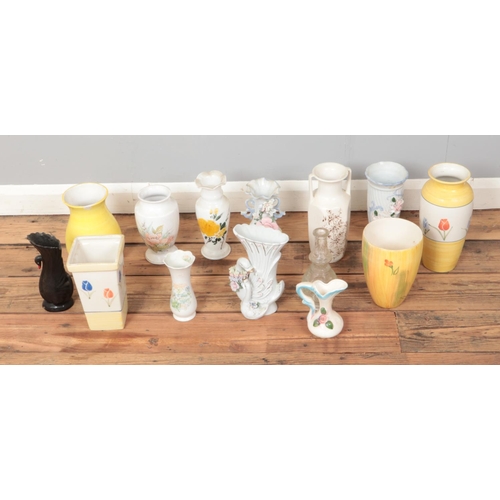 313 - A box of assorted ceramic and glass vases to include floral and novelty swan examples.