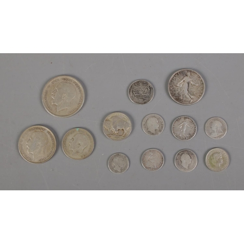 389 - A collection of silver and half silver world coins including 1928 US Five cent, three pences and 192... 