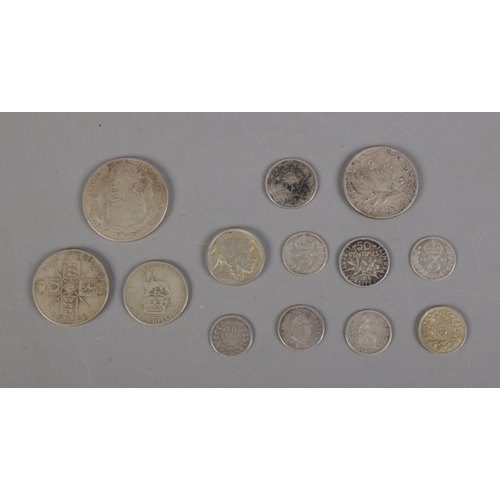 389 - A collection of silver and half silver world coins including 1928 US Five cent, three pences and 192... 