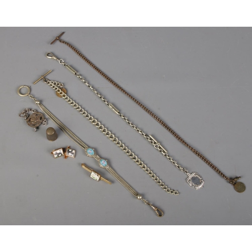 423 - A small quantity of jewellery. Including Albert chains, enamel Albertina, dog cuff links, etc.