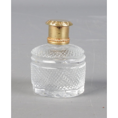 457 - A silver gilt topped scent bottle.