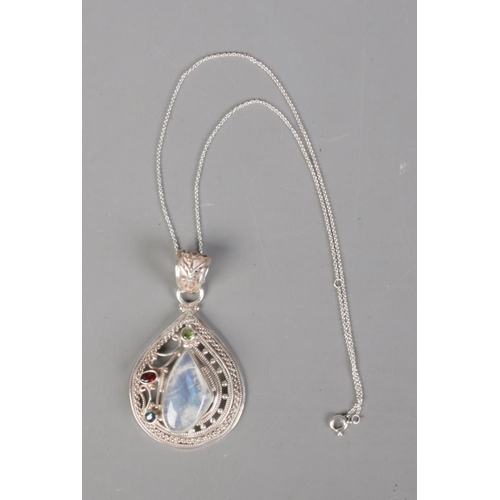 460 - A silver gemstone pendant on chain. Possibly moonstone center.