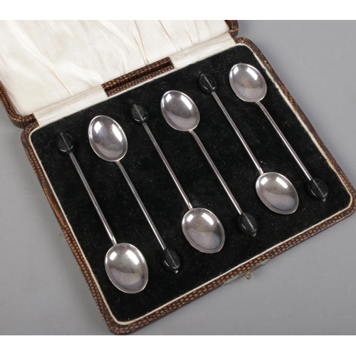 487 - A cased set of six demitasse spoons with coffee bean finials. Assayed Birmingham 1924 by William Suc... 