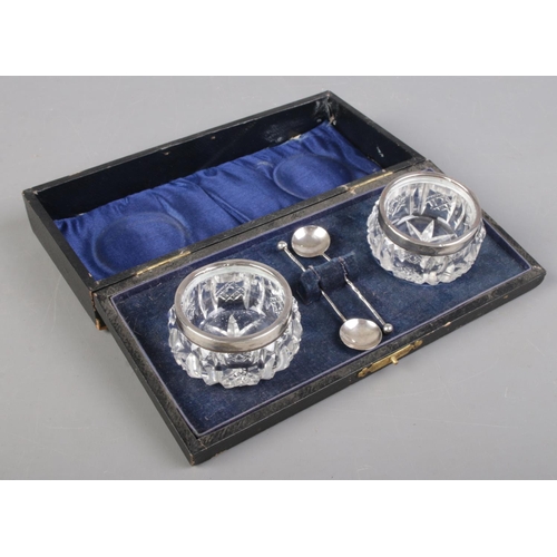 492 - A cased set of silver rimmed salts and spoons. Assayed London 1914 by Henry Perkins & Son.