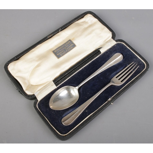 495 - A cased silver spoon and fork. Assayed Sheffield 1918 by James Dixon & Sons Ltd. 60g