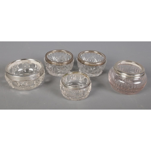 503 - Five silver rimmed cut glass salts.