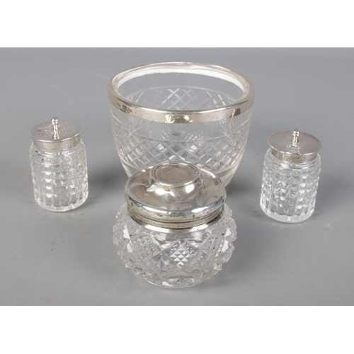 508 - A cut glass silver rimmed bowl along with three silver lidded jars.