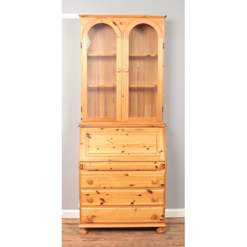 534 - A lockable modern pine bureau bookcase, with fitted interior and glass shelves. Height: 209cm, Width... 