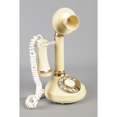 127 - A cream Deco-Tel candlestick telephone, model no. AAI 4102.